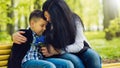 The son gives his mother a fresh bouquet of blue muscari flowers on a bench in the park. Royalty Free Stock Photo