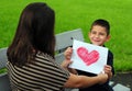 Son giving mom heart drawing