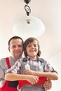 Son helping father changing a lightbulb