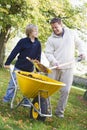 Son helping father collect leaves