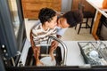 Son is helping mother in the Kitchen, Washing Dishes Royalty Free Stock Photo