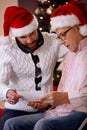 Son and his father watching photo and share memory on Christmas Royalty Free Stock Photo