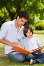 Son with his father looking at their album photo