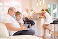 Son with his father sitting on the couch, looking at the laptop, in the kitchen mom friends and baby Royalty Free Stock Photo