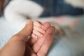 Son holds father by the hand. close-up. Closeup of a senior man and girl holding hands Royalty Free Stock Photo