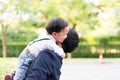 A son hug his father and smile with casual suit in the park Royalty Free Stock Photo