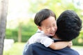 A son hug his father and smile with casual suit in the park Royalty Free Stock Photo