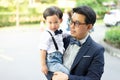 A son hug his father and smile with casual suit in the park Royalty Free Stock Photo