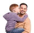 Son hugging and kissing father on white background