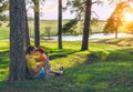 Son hugging and kissing his father. Family holiday in the pine forest on the shore of the lake. Royalty Free Stock Photo