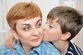 Son hugging and kissing his mother Royalty Free Stock Photo