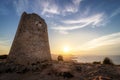 Son Jaumell watchtower at sunset with sun flare, located between Cala Agulla and Cala Mesquida, Mallorca, Spain