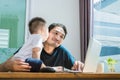 Son kissing his father while using internet. People and Lifestyles concept. Technology and Happy family theme. Single dad theme. Royalty Free Stock Photo