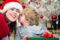 Son kissing his mother on Christmas morning. Royalty Free Stock Photo