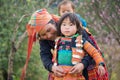 Son La, Vietnam - Jan 13, 2016: H`mong girl child wearing traditional clothes with her mother in Ta Xua village, Bac Yen district Royalty Free Stock Photo