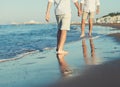 Son legs go to his father on the sea surf line close up image Royalty Free Stock Photo