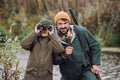 Son looking through binoculars where father showing Royalty Free Stock Photo