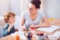 Son and mother painting together