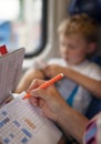 Son with mother playing a sea battle game during train trip Royalty Free Stock Photo