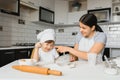 Son and mother preparing dough together Royalty Free Stock Photo