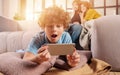 Son plays online with smartphone. Concept of addiction, dependency, problem