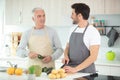 son and senior father cooking in kitchen Royalty Free Stock Photo