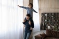 Son sits on father shoulders enjoy playtime at home