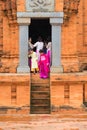 Son Tay, Vietnam - Nov 15, 2015: Vietnamese tourists in traditional dress Ao Dai visiting Champa temple - Hidu Tower in Ethnic vil Royalty Free Stock Photo