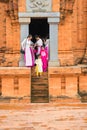 Son Tay, Vietnam - Nov 15, 2015: Vietnamese tourists in traditional dress Ao Dai visiting Champa temple - Hidu Tower in Ethnic vil Royalty Free Stock Photo