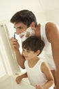 Son Watching Father Wet Shaving With Razor