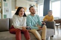 Son watching while mother and father playing video game Royalty Free Stock Photo