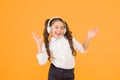 The song clicks with her mood. Adorable little girl singing a song on yellow background. Cute small child listening to Royalty Free Stock Photo