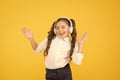 The song clicks with her mood. Adorable little girl singing a song on yellow background. Cute small child listening to Royalty Free Stock Photo