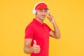 This song is so good. Unshaven man give thumbs up yellow background. Like and approval sign. Handsome guy listen to song Royalty Free Stock Photo
