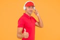 This song is so good. Unshaven man give thumbs up yellow background. Like and approval sign. Handsome guy listen to song Royalty Free Stock Photo