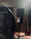 song recording, condenser microphone in a recording studio, speaker and guitar