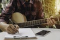 A Song writer holding pen for compose a song. Musician playing acoustic guitar. Live music and abstract musical concept Royalty Free Stock Photo