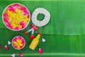 Songkran Festival background with jasmine garland Flowers in a bowl of water, perfume and limestone on a green wet banana leaf