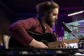 Songwriter composing a new song on acoustic guitar in home studio Royalty Free Stock Photo