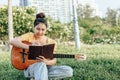 Songwriter create and writing notes,lyrics in the book grass at parks Royalty Free Stock Photo