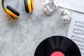 Songwriter or dj work place with vynil and headphones on stone background top view mockup