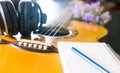 Songwriter with guitar notebook for songwriting