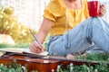 Songwriter writing on notebook with acoustic guitar, holding coffee cup Royalty Free Stock Photo