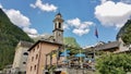 Sonogno, typical Ticino Village in Verzasca Valley, Switzerland, with church tower and restaurant terrace. Royalty Free Stock Photo