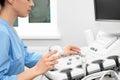 Sonographer operating modern ultrasound machine Royalty Free Stock Photo