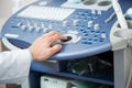 Sonographer using ultrasound machine at work.