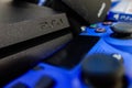 Sony black Playstation 4 Pro game console and blue wireless controller Royalty Free Stock Photo