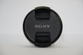 Sony Camera Lens Cap on white background. Branded cap of camera lens named Sony as accessories for those whose hobby in Royalty Free Stock Photo