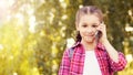 Pretty girl using cellphone. Holding mobile phone. Smiling beauty portrait Royalty Free Stock Photo