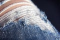 blue jeans worn out, holes on jeans, threads stick out, Torn jeans on the legs close-up Royalty Free Stock Photo